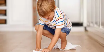 Des enfants apprennent comment rendre les planchers de bois propres