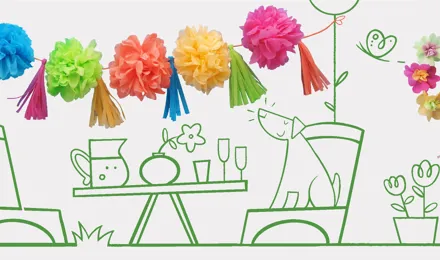 Un chien assis à table avec des flûtes à champagne, une vase, une carafe, et des pompons sur une ficelle au-dessus.
