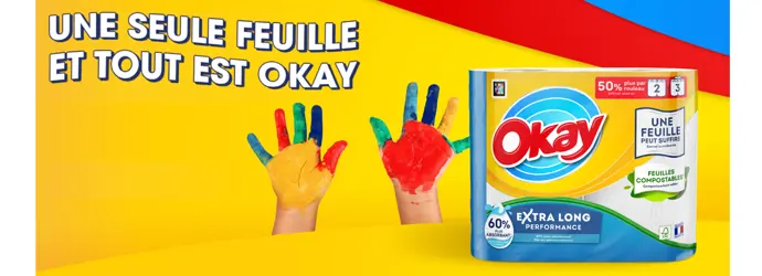 Publicité avec l'essuie-tout Okay Extra Long 2=3 rouleaux, le slogan "une seule feuille et tout est okay" et des mains d’enfants avec de la peinture au couleur de Okay.
